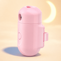 Moonpaw pink custom pet collar projector on a warm cream studio background